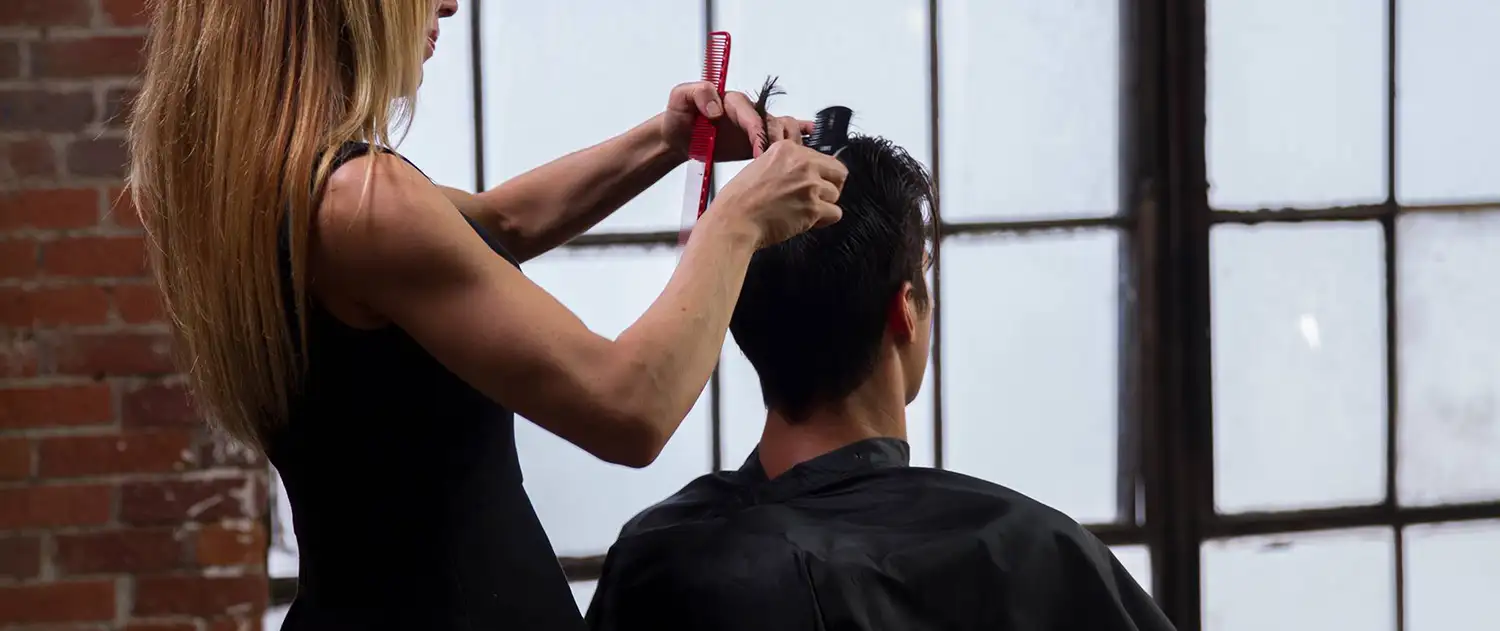 stylist cutting man's dark hair - Edwardsville, IL