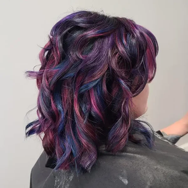 The Experience Hair Studio - beautiful finished product of hair cut, color and styling - mix of fashion colors purple, pink, and blue on black hair - Edwardsville, IL