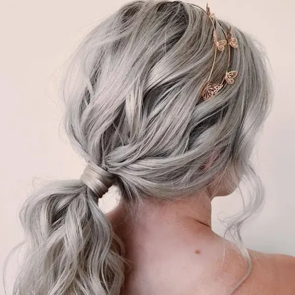 The Experience Hair Studio - special occasions hair styling with fashion color (grey/silver) - low ponytail, curled, with metallic butterfly headband - Edwardsville, IL